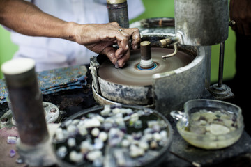  Polishing moonstone at the factory for the extraction and processing of precious stones. Soft selective focus.
