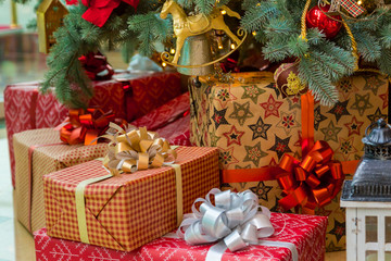 Fototapeta na wymiar Luxury New Year gifts, different present boxes under Christmas tree in holiday eve, Christmastime celebration, home decorated with festive shiny balls, magic night