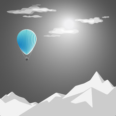 Fototapeta na wymiar The blue hot-air balloon flies on a background of clear nights and mountains
