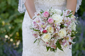 Bride in Lace Dress Holding Bridal Bouquet with Pink and White Wedding Flowers
