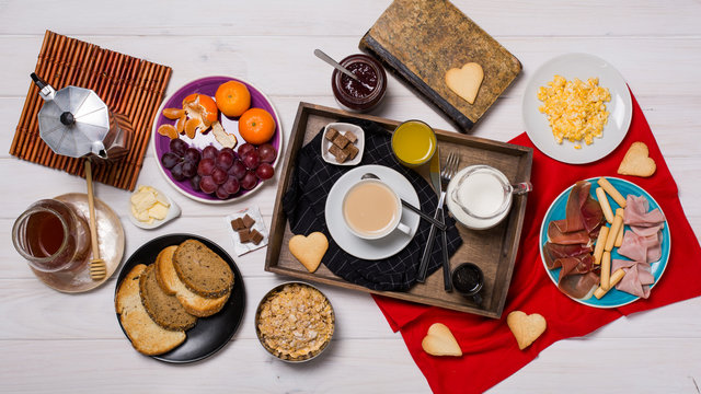 Complete breakfast sit on a wooden white table