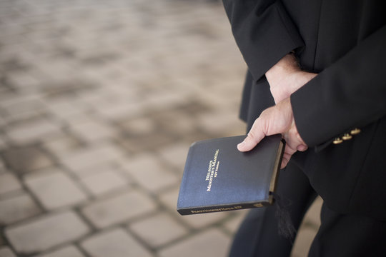 Pastor Holding A Bible