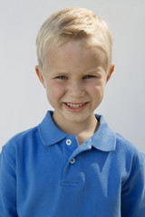 Portrait of a Caucasian boy smiling isolated over white background