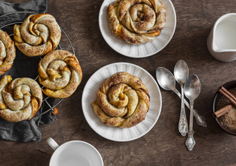 Pumpkin cinnamon puff pastry swirls rolls on a wooden table, top view