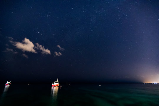 stars over the ocean with boats