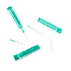 Fototapeta premium Medical syringes with needles lying isolated over white background