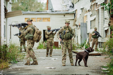 Soldiers on patrol in destroyed city. Military and rescue operation