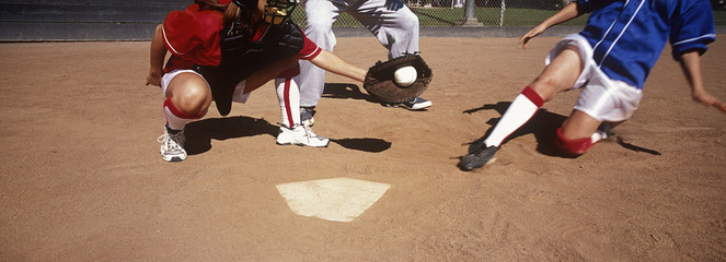 Low section of players playing baseball on field