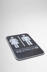 Isolated restroom sign over gray background