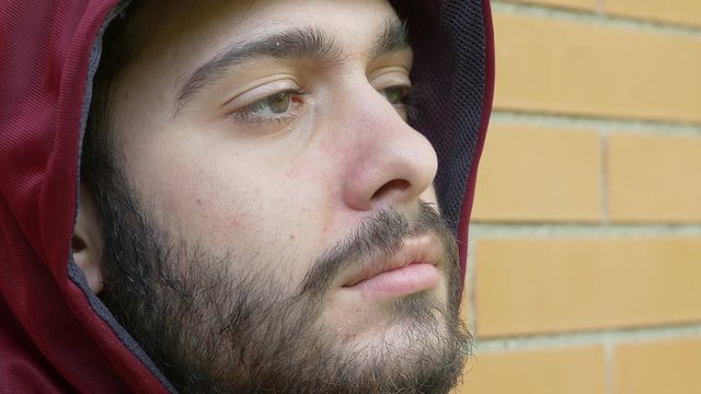 whit guy in hoodie closes his eyes, drug effects, beard