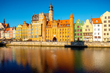 Fototapeta na wymiar Morning view on the riverside of Motlawa river with beautiful buildings of the old town in Gdansk, Poland