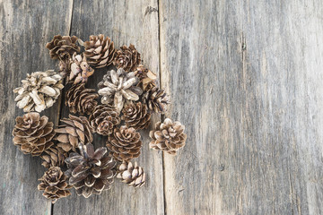 Fir,pine cones on old wooden background with space for text