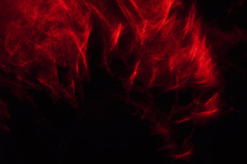 Fototapeta premium Abstract composition of red smoke in the dark