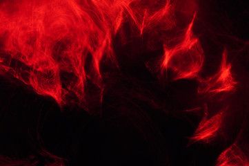 Abstract composition of red smoke in the dark