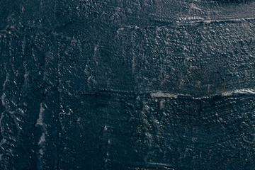 Dark grunge textured wall closeup