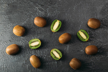 Kiwi fruits are on top of the black kitchen table
