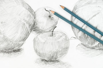 Two pencils lie on the drawing of apples