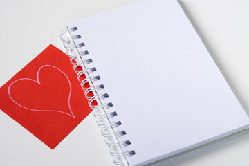 Notebook and sheet painted with a heart