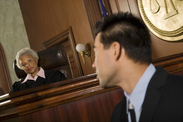 Senior judge and witness looking at each other in the courtroom