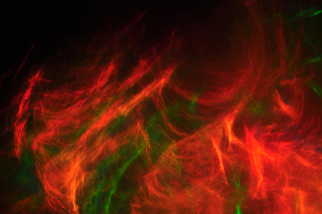 Abstract composition of dark colored smoke in the dark, red, blu