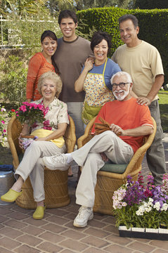 Portrait Of A Happy Three Generation Family In Garden