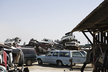 Fototapeta premium Cars stacked in junkyard