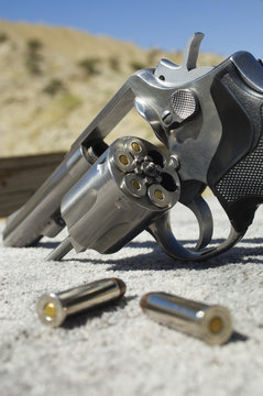 Closeup of bullets beside handgun