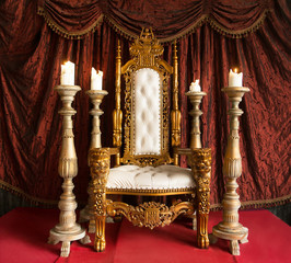 Royal throne of gold on red curtain background