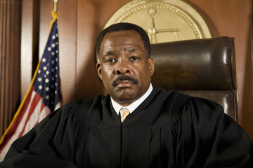 Portrait of a male judge sitting in courtroom