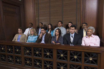 Group of jurors sitting together in jury box during trial