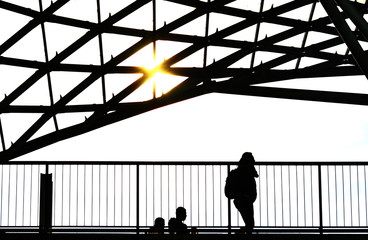 Naklejka premium Silhouette of a young woman while walking in a city of the future.
