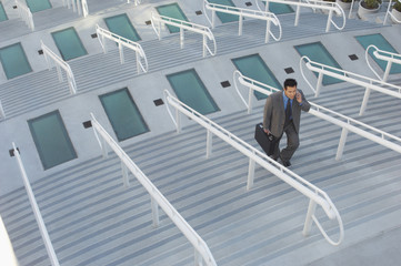 High angle view of businessman walking up stairs