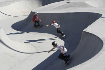 High angle view of friends skateboarding in park © MDBPIXS