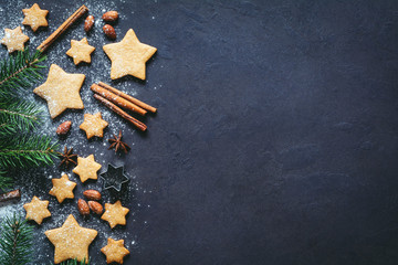 Christmas or New Year background with gingerbread cookies, spices, nuts, flour and fir tree. Copy space for text - obrazy, fototapety, plakaty