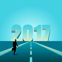 Businessman walking towards the year 2017