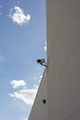 Low angle view of security cameras mounted on building wall