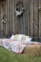 Hay Bales Covered with Quilts on the side of a Barn