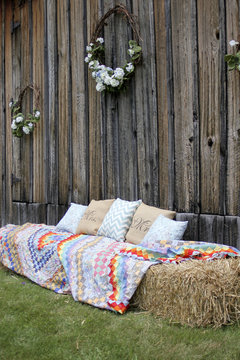 Hay Bales Covered With Quilts On The Side Of A Barn