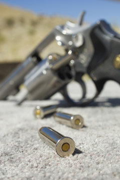 Closeup of a bullets beside gun