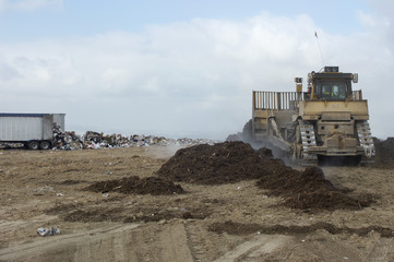 Excavator loader machine at landfill site