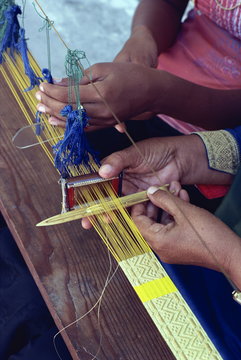 Weavers hands using a narrow loom in the Maldive Islands