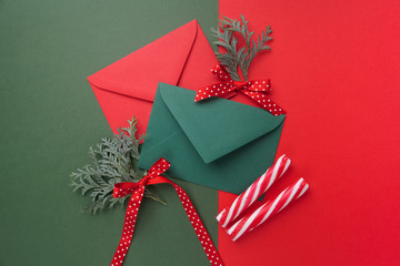 Red and green envelopes on christmas holiday background. Flat lay.