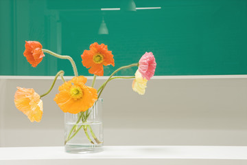 Closeup of fresh flowers in vase on counter at home
