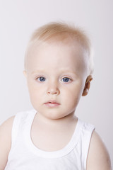 Closeup portrait of a cute baby boy against white background