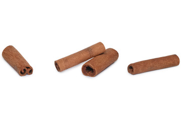 Four cinnamon sticks on white background with shadow