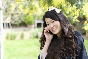 Close up portrait of young woman talking on mobile phone