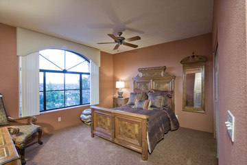 Spacious bedroom with outdoor view through window in a house