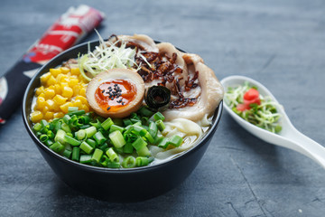 japanese tonkotsu ramen, pork bone broth noodles with chashu, egg, corn and scallions