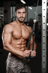 Strong and handsome athletic young man muscles abs and biceps.