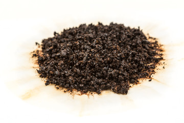 Used coffee grounds isolated on white background